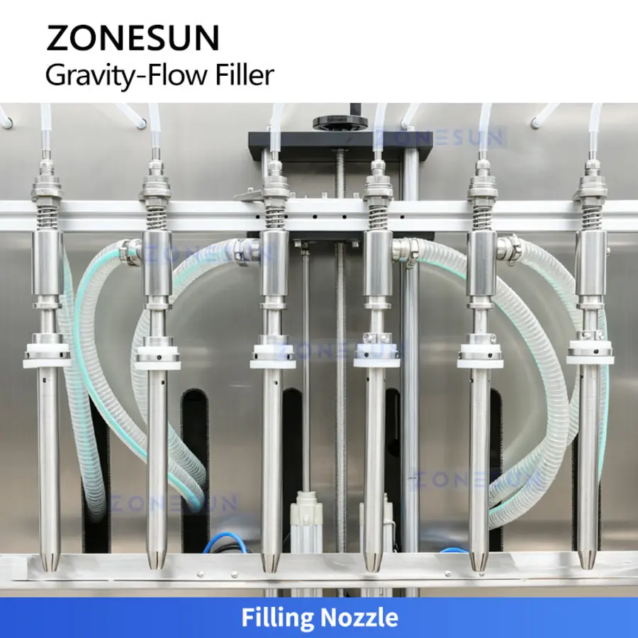 Six stainless steel filling nozzles aligned on a beverage filling machine above a metal platform.