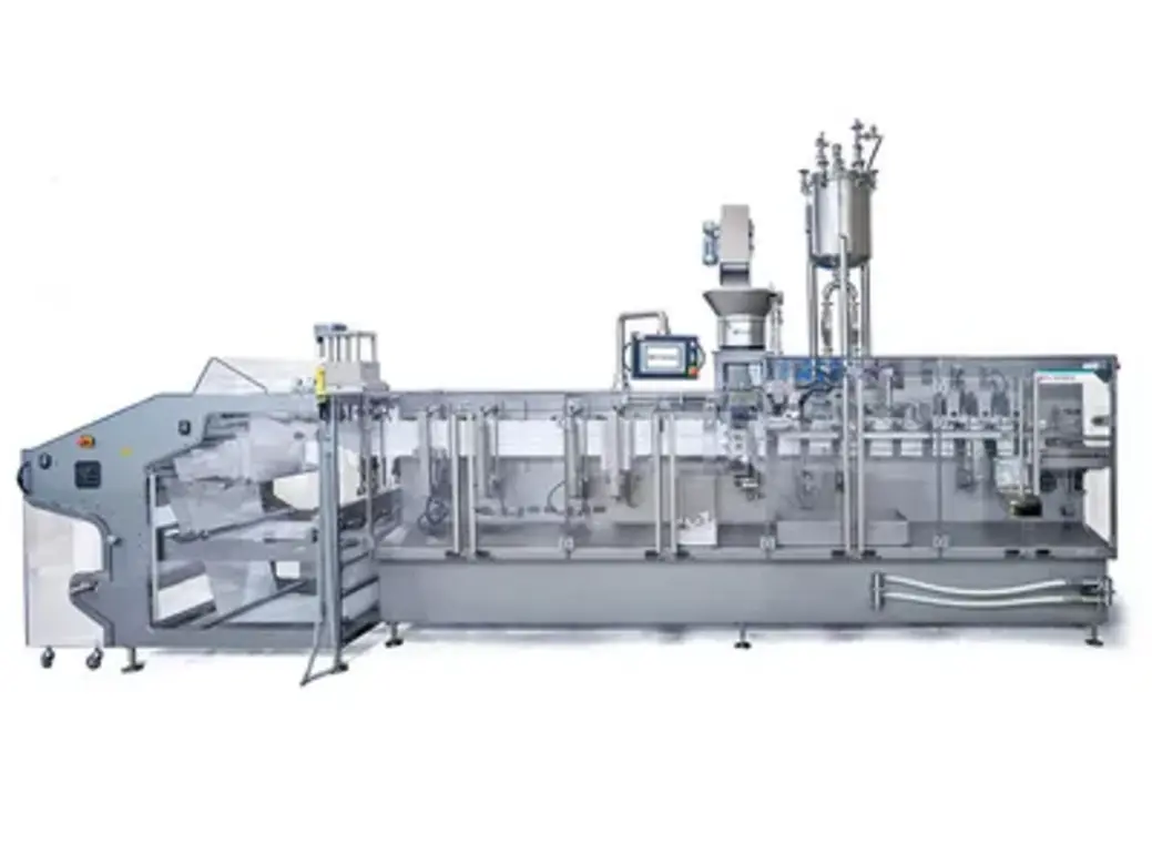 Stainless steel industrial packaging machine with film handling, sealing stations, control panel, and vertical components.