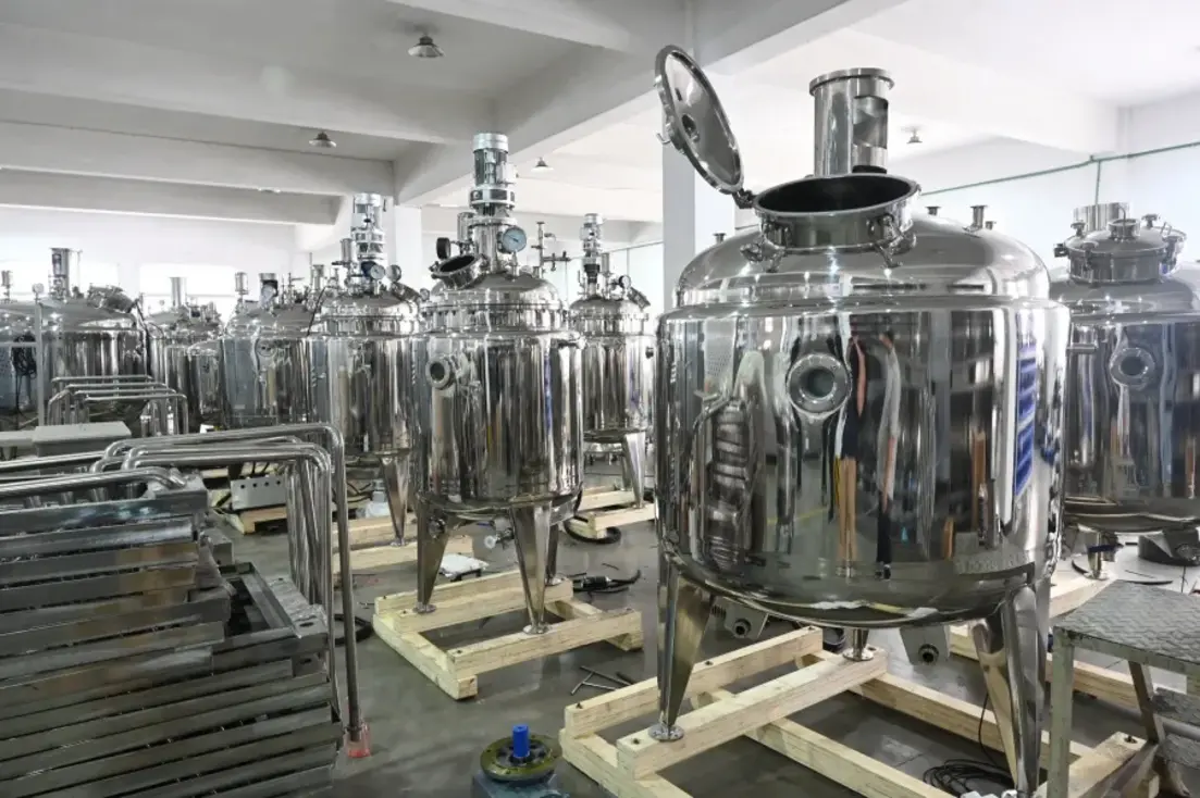 Stainless-steel food-processing vessels with polished product-contact surfaces arranged in an industrial facility.
