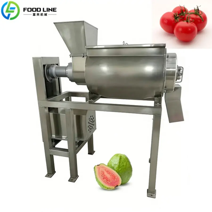 Stainless steel food processing machine with hopper, discharge chute, and tomato and guava images.