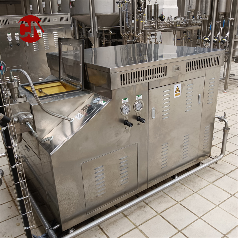 Stainless steel high-pressure homogenizer installed in an industrial dairy processing line