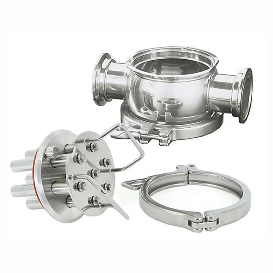 Stainless steel magnetic trap components including a main body, flange, and clamp.