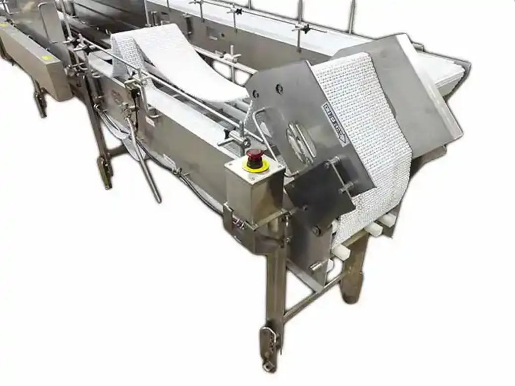 Food processing equipment with conveyor belt and safety features displayed.