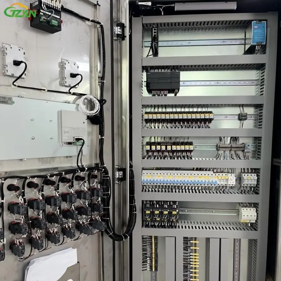 Electrical control panel with various modules, wiring, and connections visible.