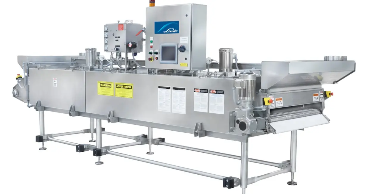 Industrial tunnel freezer with a linear layout and conveyor arrangement.