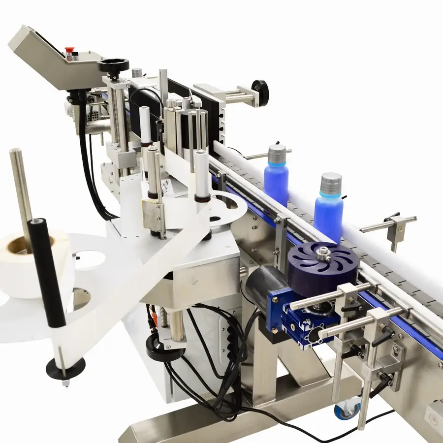 Industrial labeling machine with bottles, rollers, and applicators in operation.