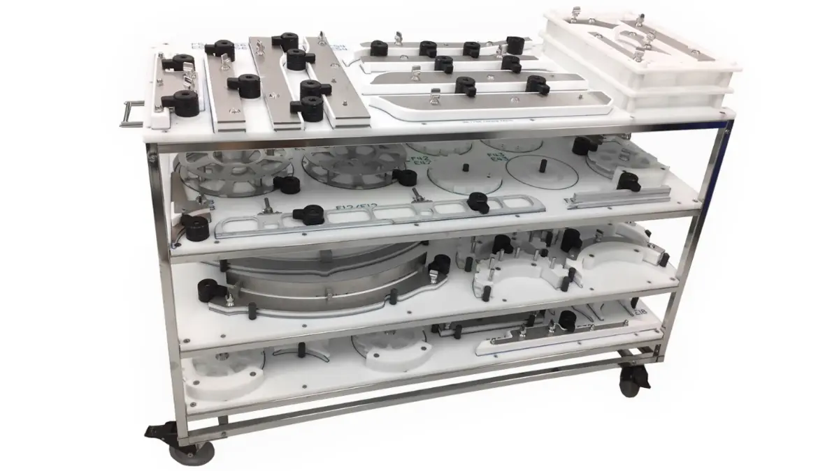 Organized cart with various packaging line components and tools for preparation.